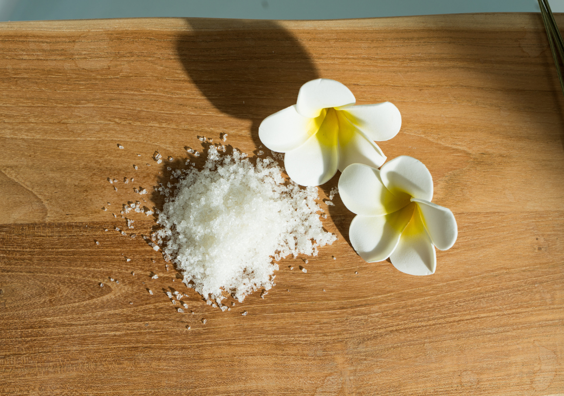 Hawaiian sea salt used in magnesium bath soak with plumeria flowers