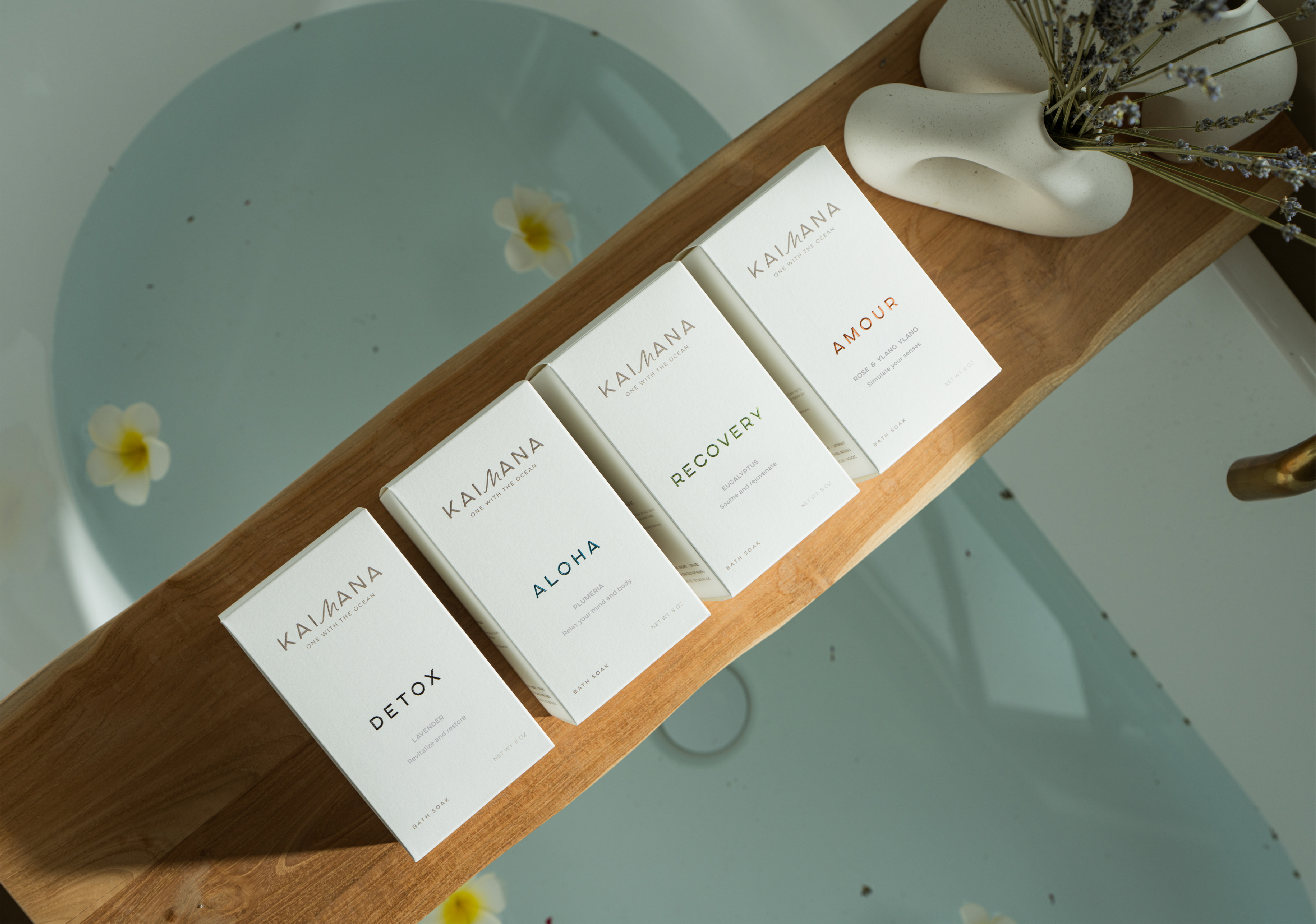 Kaimana magnesium bath soak collection displayed on wooden bath tray